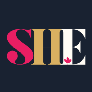 The logo for "SHE" featuring the word "SHE" in bold, stylized letters. The "S" is pink, the "H" is gold, and the "E" is white, with a small red maple leaf in the center of the "H," set against a dark blue background. Square size